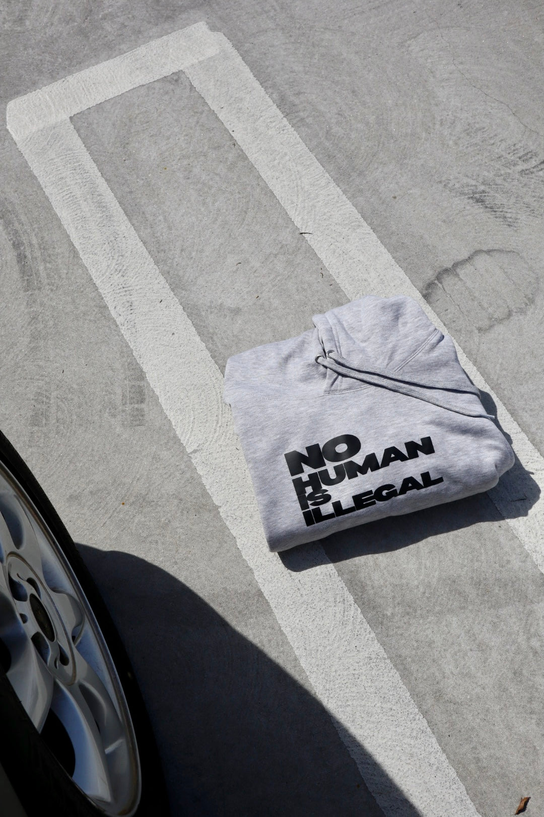 "No Human Is Illegal" Hoodie in Grey Chia
