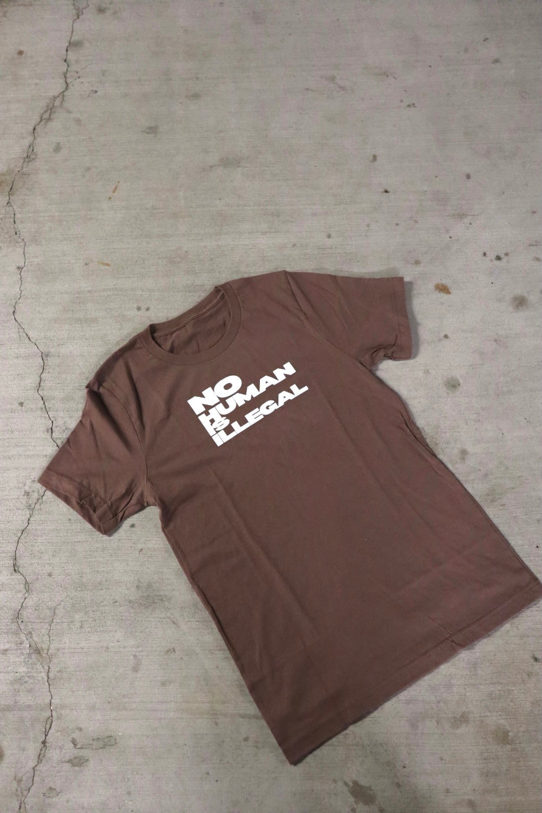 “No Human is Illegal” Full Length Tee in Coffee